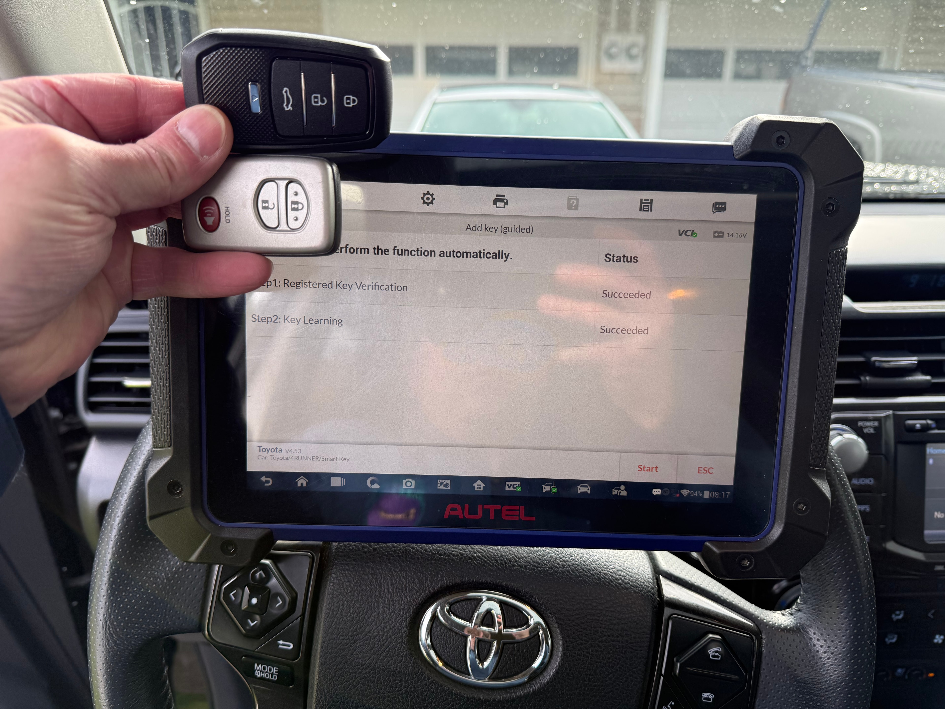 Autel showing Toyota 4Runner add key succeeded with two smart fobs held up — Orion's Key Vancouver WA
